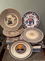 Four assorted plates displayed together