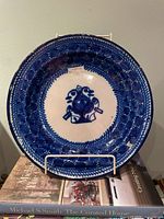 Front view of cobalt blue maiolica plate on stand