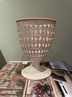 Side view of pierced vase showing lattice body and pedestal foot
