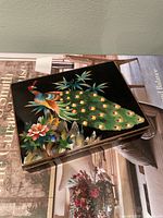 Top view of cloisonné box showing peacock design