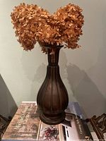 Full view of copper vase with fluted body and patina