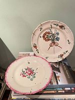 Two hand-painted faience plates, front view