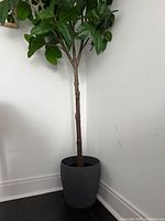 Full view of artificial tree in grey pot