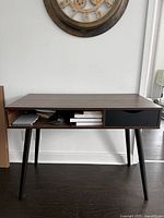 Front view of walnut-finish desk showing drawer and open cubby
