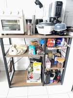 Full view of kitchen island with wood shelves and metal frame