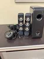 Two satellites, subwoofer, control pod and wiring visible