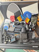 Overall view of mixed photography accessories laid out on black background