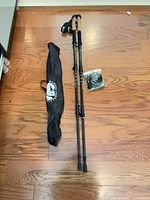 Full view of two trekking poles with carry bag and accessory pack