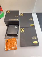 Retail boxes, filter holder case and wipe packets on tabletop