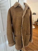 Full front view of Timberland tan shearling coat on mannequin