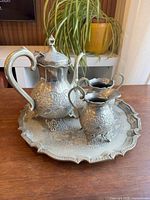 Full view of teapot, two pitchers and tray