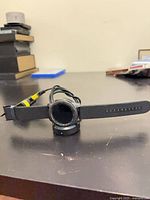 Front view of Samsung Gear S3 smartwatch on charging dock with strap extended