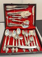 Full view of flatware set in black case with red lining