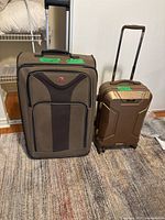 Front view of both suitcases upright with handles extended