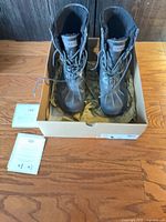 Boots inside box with documents visible