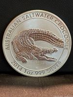 Reverse of 2014 Saltwater Crocodile coin showing crocodile design, legends and mintmark