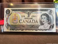 Front of 1973 Canadian $1 note showing serial ECS3366594, Queen Elizabeth II, coat of arms