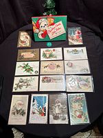 Overview of approx 15 postcards and Hallmark box laid on table