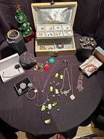 Overview showing jewellery chest, necklaces, bracelets, watch, tree