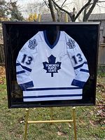 Full view of framed autographed Mats Sundin Toronto Maple Leafs jersey on stand