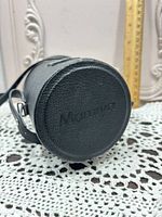 Top view of black leatherette cylindrical lens case embossed Mamiya