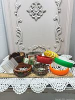 Group view of all ten bracelets arranged on lace surface