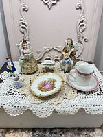 Group view of all porcelain items on doily