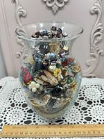 Vase filled with multicolour costume jewelry pieces
