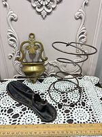 Overall view: brass wall pocket, cast iron shoe last, metal coil spring together