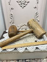 Both wooden mallets alongside ruler for scale