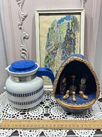 Group shot showing coffee carafe, framed print and nativity set