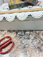 Two Better Little Books stacked with ruler and lace background