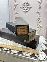 Two black boxed piano rolls stacked; end label visible with catalogue L12 88045