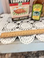 Both items together: Trappey’s tin, Moone’s bottle, box partly visible