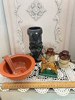 Group shot showing tiki mug, bowl with ladle, jug shakers and horse figurine