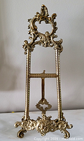 Full view of brass Rococo easel stand showing overall design