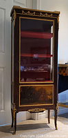 Full front view showing single-door vitrine, marble top, painted panel, ormolu mounts