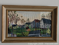 Front view of framed village landscape painting