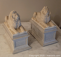 Front view of both lion bookends on bases
