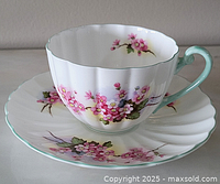 Cup and saucer front view showing floral pattern and handle color