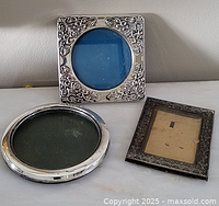 Three frames: round sterling silver, square silver-plated, rectangular metal