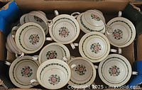 Box containing 12 Wedgwood two-handled cups, overhead view shows quantity and matching pattern