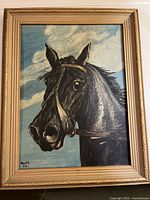 Front view of framed oil painting of black horse