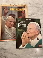 Cover view of both newspaper tributes