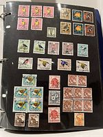 Album page with assorted Australian stamps in multiples and singles