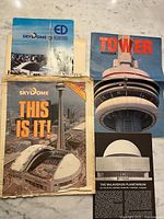 Front covers of several brochures featuring CN Tower, SkyDome, Planetarium