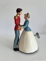 Side view of tin wind-up dancing couple toy with key