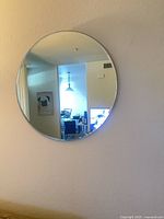 Mirror hung on wall reflecting room view