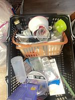 overview of black crate with assorted kitchen items