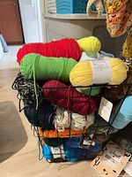 Wire basket with multiple coloured yarn skeins stacked